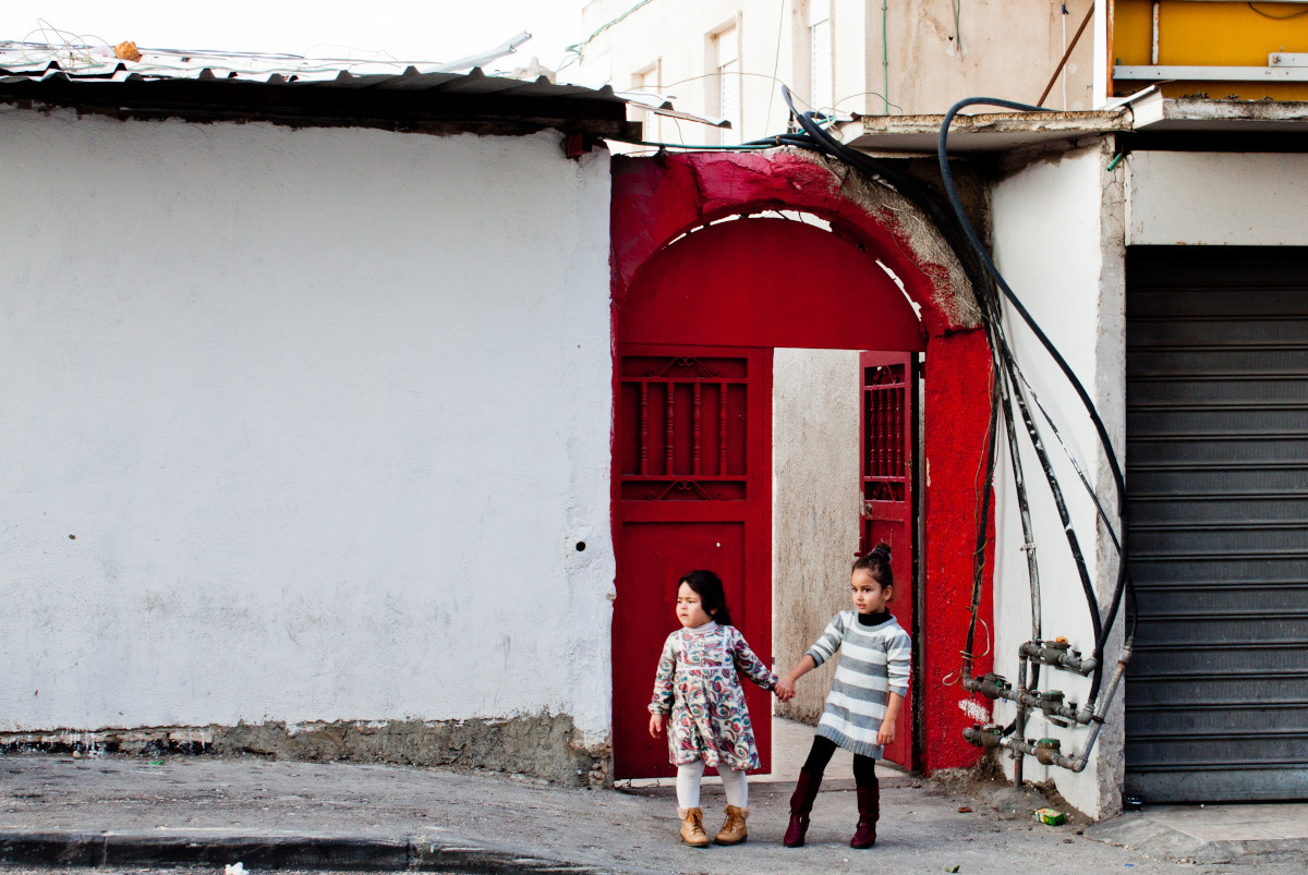 Girls in Jerusalem with red doors