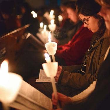 Girls with candles reading