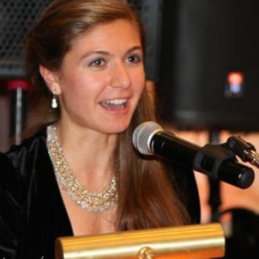 Spyridoula Fotinis speaking at a lectern