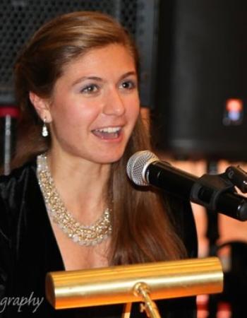 Spyridoula Fotinis speaking at a lectern