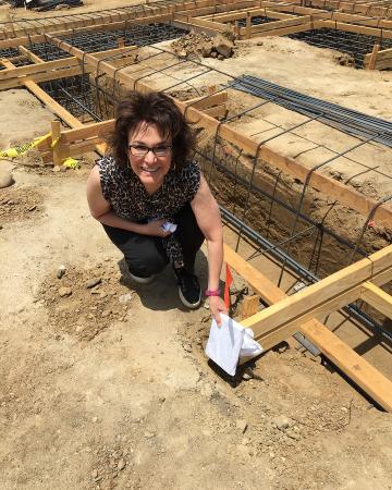 Photo of Beth Rustigian Broussalian at the building site of the church.