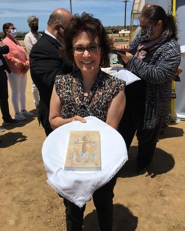 Photo of Beth with a cross in her hand.